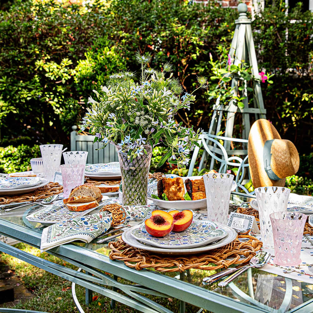 Al fresco table in a garden with florals and Villa Seville ceramics